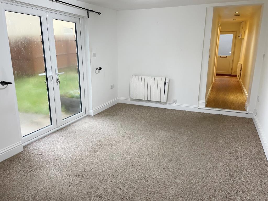 Lot: 145 - DETACHED BUNGALOW IN TOWN CENTRE - View of living room with doors to garden